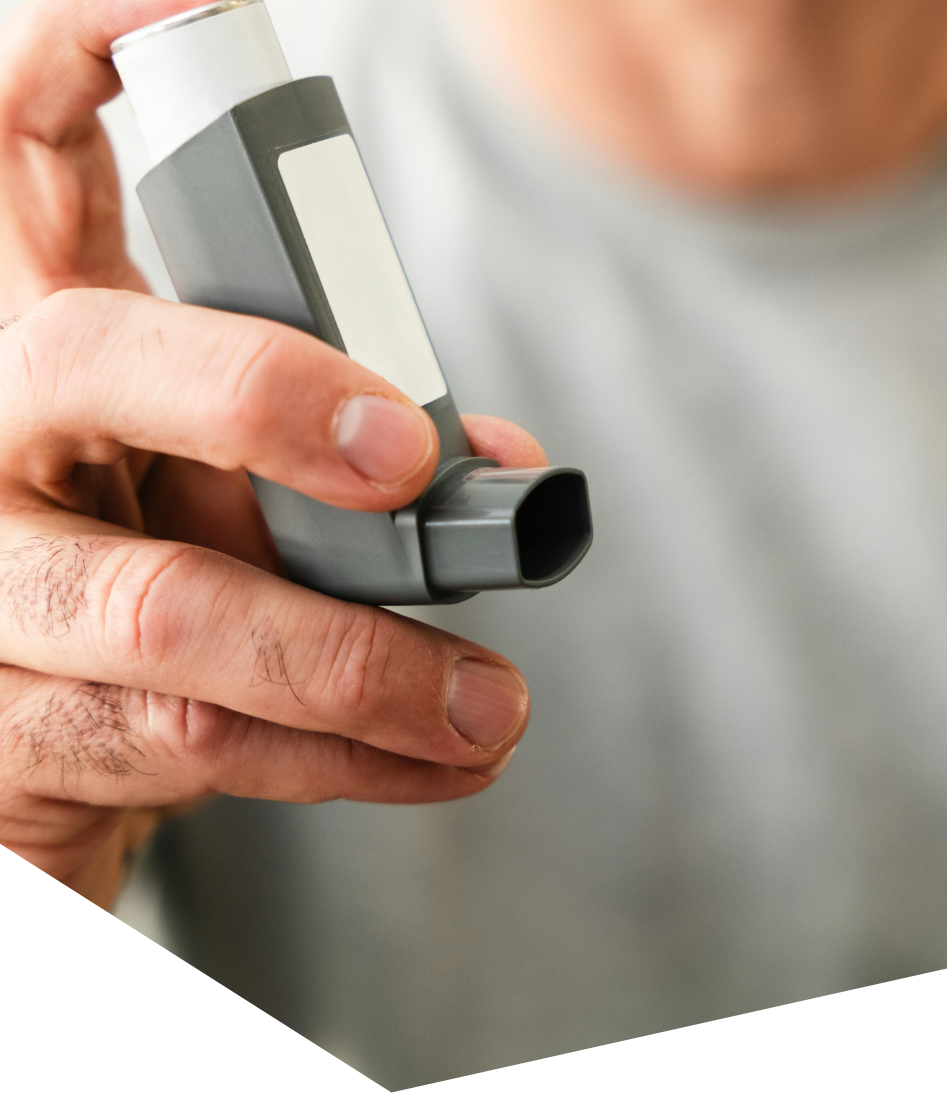 Patient using an asthma inhaler, one of the chronic conditions managed by Kilcoy GPs