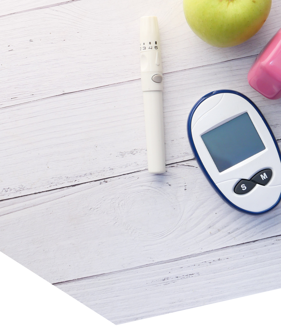 Blood glucose meter, lancet device and an apple, representing type 2 diabetes treatment and lifestyle care