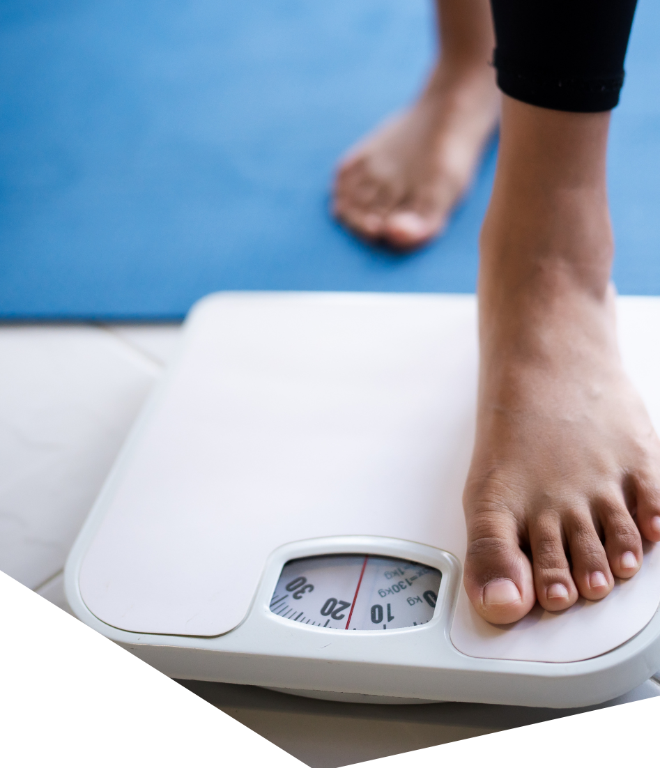 Nurse recording a patient's weight as part of a baseline assessment